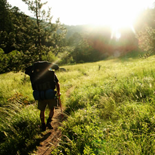 man hiking down trail